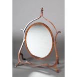 A MAHOGANY TOILET MIRROR c.1900, the oval glass with boxwood stringing, within an open shield