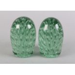 A MATCHED PAIR OF 19TH CENTURY GREEN GLASS DUMPS, inset with a rush of bubbles, 12cm high
