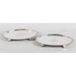 A PAIR OF LATE GEORGE III SILVER SALVERS BY JOHN MEWBURN, London 1806, of oval outline with