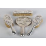 A CHINESE FOUR PIECE SILVER BACKED DRESSING TABLE SET, each piece embossed with a sinuous dragon