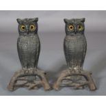 A PAIR OF 19TH CAST IRON FIREDOGS IN THE FORM OF OWLS, perched upon a branch, yellow and black glass