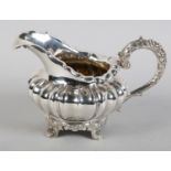 A LATE GEORGE III/GEORGE IV SILVER CREAM JUG BY JOHN WALTON, Newcastle, c.1820, compressed fluted