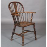 A 19TH CENTURY ASH AND ELM WINDSOR LOW BACK ARMCHAIR having a pierced splat and rail back, turned