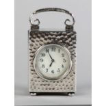 A PLANISHED SILVER CASED BOUDOIR CLOCK BY GOLDSMITHS AND SILVERSMITHS CO. LTD, London 1901, the