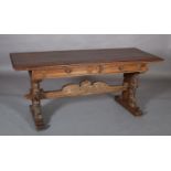 A 19TH CENTURY ITALIAN WALNUT TRESTLE TABLE in the Renaissance style, having a planked top with