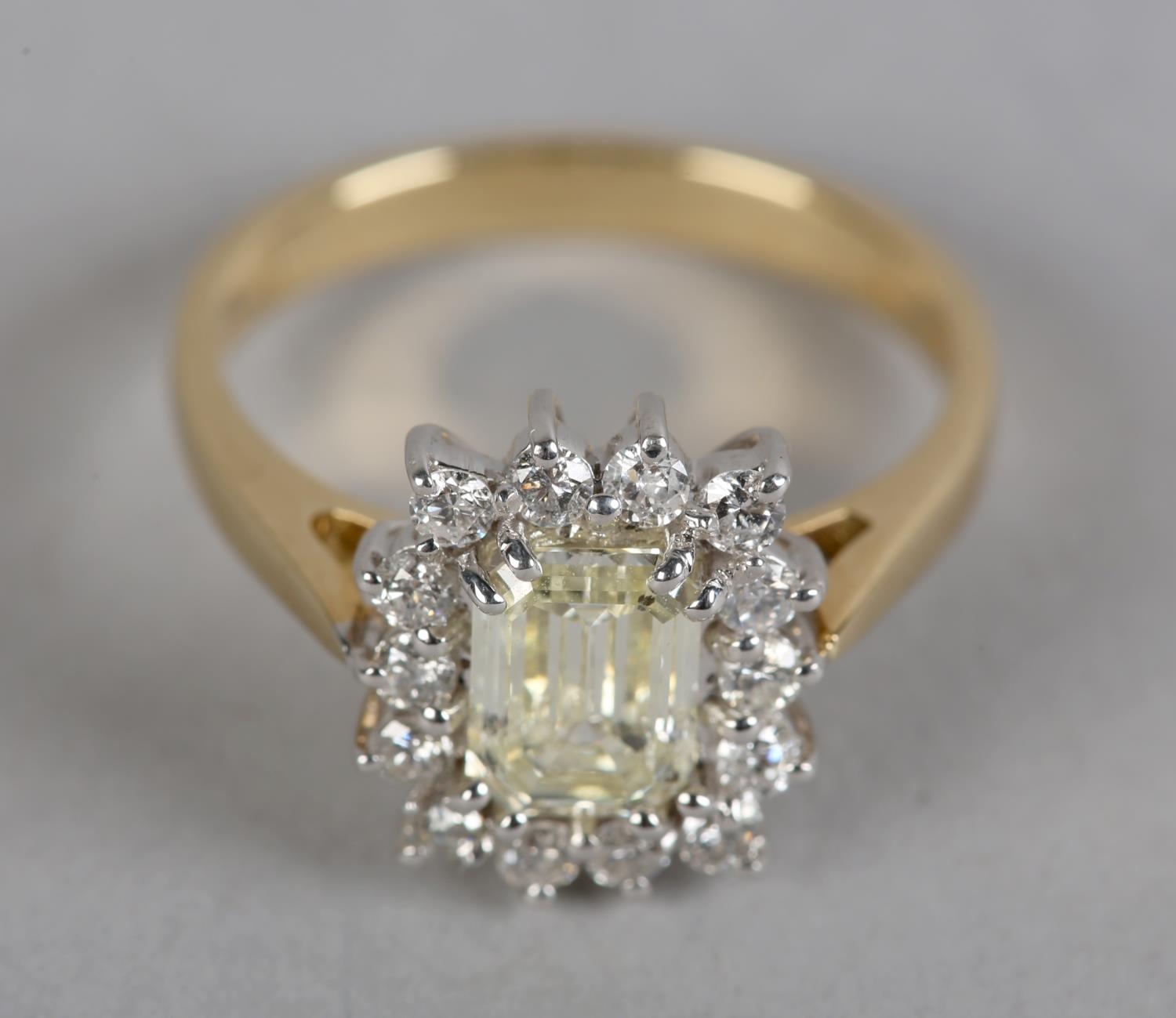 A DIAMOND CLUSTER RING in 18ct yellow and white gold, the step cut stone claw set to the centre - Image 2 of 5