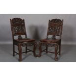 A PAIR OF CHINESE HARDWOOD SINGLE CHAIRS, the back carved and pierced with sinuous dragons, the