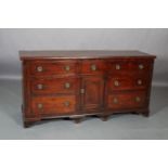 A 19TH CENTURY MAHOGANY DRESSER BASE, having a small drawer above a single indented panel door