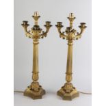 A PAIR OF 19TH CENTURY FRENCH ORMOLU FOUR LIGHT CANDELABRA, now converted to lamps, having a central