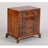 AN EARLY 20TH CENTURY WALNUT SPECIMEN CHEST OF DRAWERS, the top veneered with radiating panels and