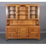 BOB HUNTER OF THIRLBY WRENMAN AN OAK DRESSER AND RACK, having a scallop carved cornice above an open