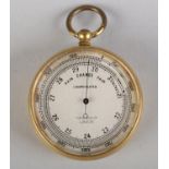 A LATE 19TH CENTURY/EARLY 20TH CENTURY POCKET BAROMETER BY HARRODS LTD LONDON, in gilt base metal