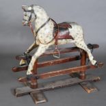 AN EDWARD VII DAPPLE GREY ROCKING HORSE, with well carved face, close nailed leather saddle and