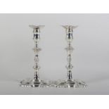 A PAIR OF GEORGE II CAST SILVER CANDLESTICKS BY WM. GOULD, London 1750, knopped baluster stems,