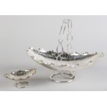 A CHINESE SILVER BASKET BY WANG HING, of oval lily pad form having an open strapwork handle and