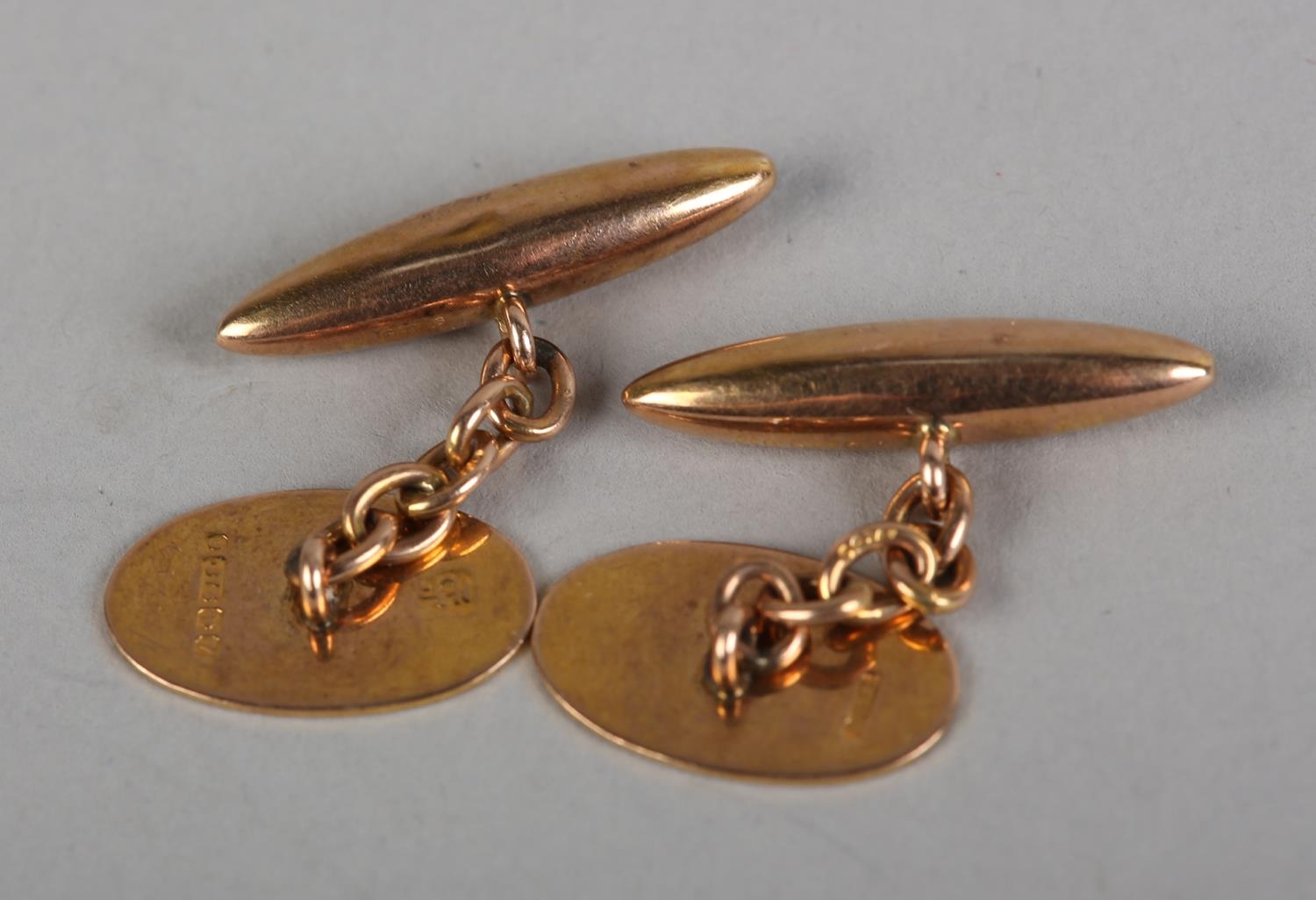 A PAIR OF GEORGE V CUFFLINKS BY G.H. JOHNSTONE & CO. in 9ct rose gold, the oval engine turned - Image 2 of 2