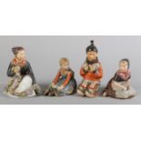 CARL MARTIN-HANSEN FOR ROYAL COPENHAGEN; a set of four figures of children in traditional costume