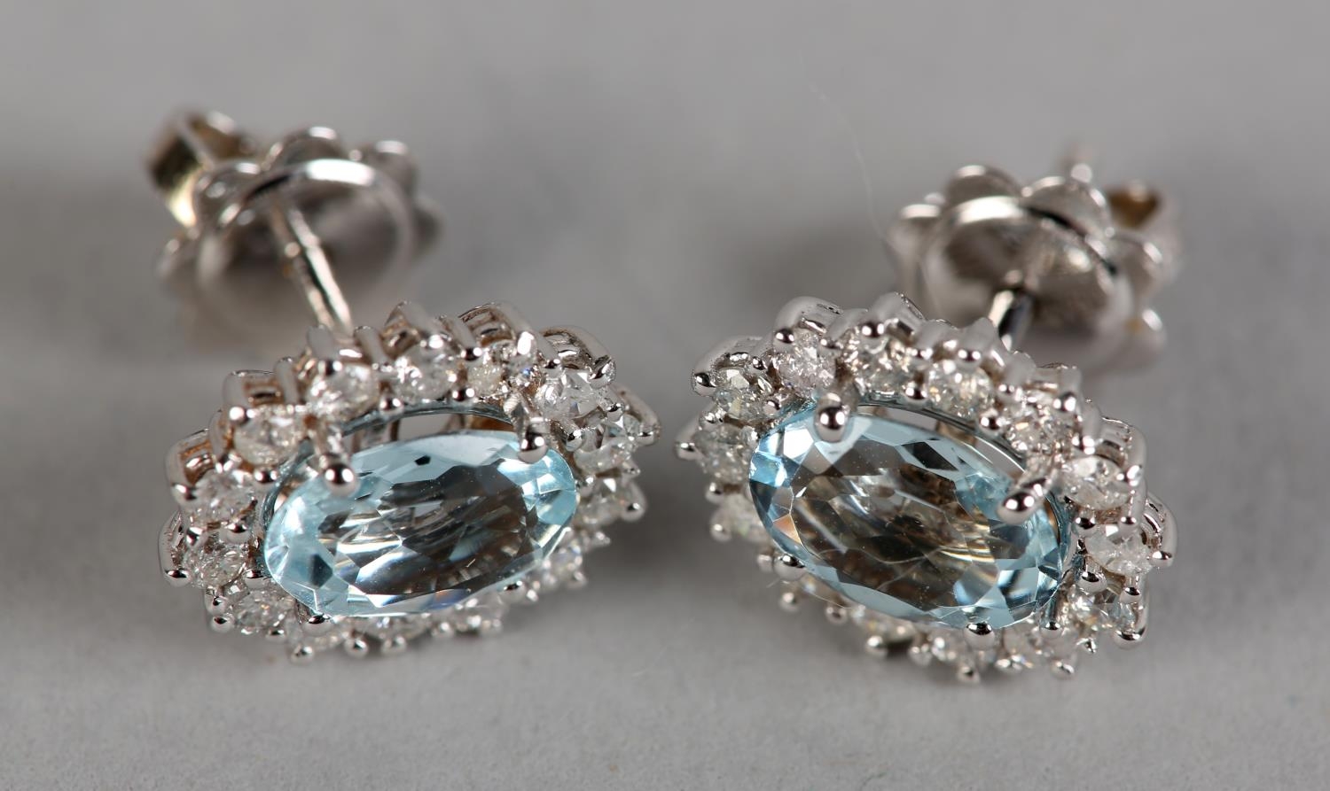 A PAIR OF AQUAMARINE AND DIAMOND CLUSTER EAR STUDS, each claw set to the centre with an oval faceted - Image 2 of 3