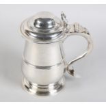 A GEORGE III SILVER LIDDED TANKARD BY JOSEPH STEWARD, London 1767, the domed cover with 'C' scroll