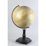 A PHILLIPS 12" TERRESTIAL GLOBE, on turned ebonised pedestal and circular base with three feet,