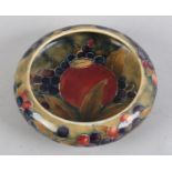 A MOORCROFT POMEGRANATE DISH made for Liberty & Co, circular shallow form, painted and tubelined