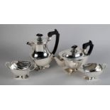 A GEORGE V FOUR PIECE SILVER TEA SERVICE, by Roberts & Dore Ltd, Birmingham 1935, of oblong panelled