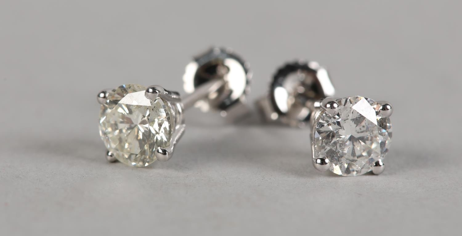 A PAIR OF DIAMOND STUD EARRINGS in 18ct white gold, each claw set with a brilliant cut stone on post