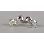 A PAIR OF DIAMOND STUD EARRINGS in 18ct white gold, each claw set with a brilliant cut stone on post