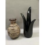A black pottery vase of flower form together with a German pottery buff and brown glazed vase