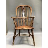 A 19th century ash and elm Windsor armchair with pierced yew wood splat on turned legs with H