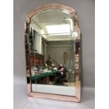 An Art Deco wall mirror, rectangular with low arched top, clear glass with peach glass margins, 88cm