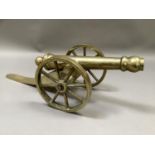 A brass model of a cannon on a two wheel carriage, overall length 51cm by 17cm high
