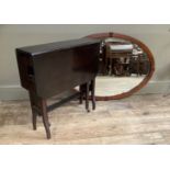 An Edwardian mahogany and satinwood line inlaid wall mirror, bevelled glass, oval outline, 96cm by