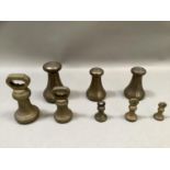 Three brass Avery weights, 7lb, 4lb and 4lb together with five bell weights, 4lb, 2lb, and two 8oz