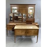 An early 20th century mahogany and crossbanded bedroom suite inlaid with mother of pearl and