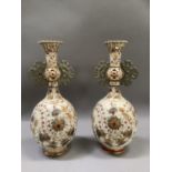 A pair of Zsolnay two handled vases having a pierced rim, knop to the neck and handles, the ovoid