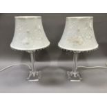 A pair of perspex lamps of square form complete with cream shades, overall height with shade 52cm