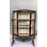 A 1940s mahogany semi circular display cabinet on short cabriole legs together with a mahogany towel