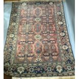 A large Caucasian carpet woven in shades of blue, red, ivory of predominately floral design, 380cm x