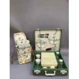 A Brexton green cased vintage picnic box together with a 1960's floral pvc picnic bag fitted with