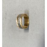 A wedding ring in 18ct yellow and white gold, approximate weight 5g