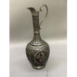 An Indian silver plated and niello ewer embossed with roundels containing figures playing musical