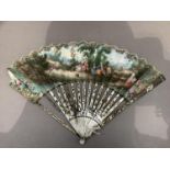 A slender 18th century painted fan, the leaf, showing a countryside gathering, mounted on white