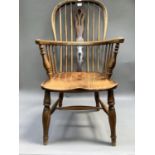 A 19th century ash and elm Windsor armchair with yew wood splat on turned legs with H stretcher