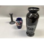 A black glass vase painted in silver with a stag together with a Moorcroft vase, tubelined and