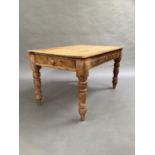 A Victorian pine plank top kitchen table with drawer to the opposing aprons on turned legs, 137cm