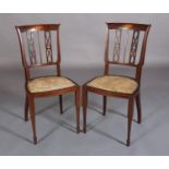A Pair of Edward VII mahogany and satinwood inlaid salon chairs, by Maple & Co Ltd., the top rail