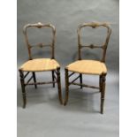 A pair of Victorian polished beech and gilt metal mounted bedroom chairs with later caning