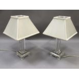 A pair of glass table lamps, square form complete with cream shades, 39.5cm