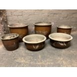 Six various garden planters, glazed in shades of brown and decorated with bamboo fronds, various